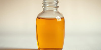 A bottle of horse chestnut extract for under eyes next to a fresh horse chestnut.