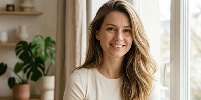 Woman with clean voluminous fresh hair in bright airy setting — sulfate free shampoo for oily hair
