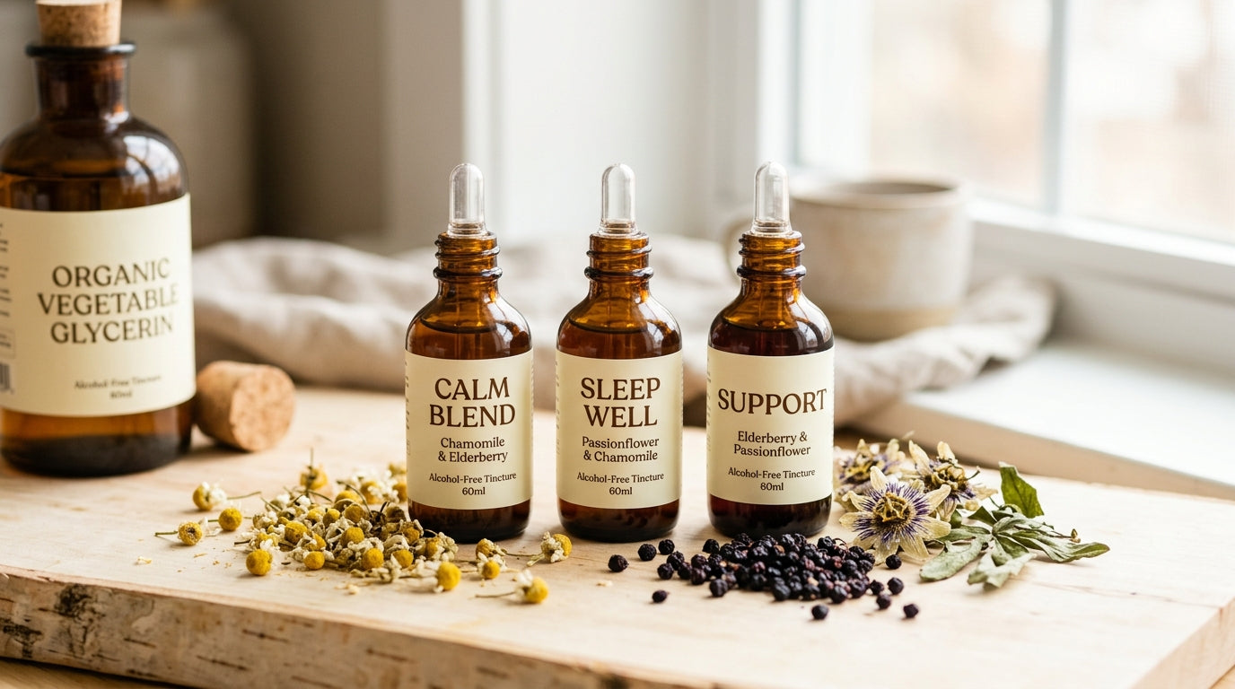 Amber glycerin-based alcohol-free herbal tinctures with fresh herbs on clean light wood surface